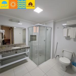 a bathroom with a glass shower and a toilet at Piazza diRoma com acesso ao Acqua Park - Temporada CN in Caldas Novas