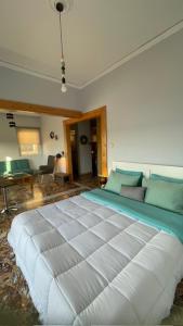 a bedroom with a large bed and a couch at appartment view sea artemida 2 in Artemida