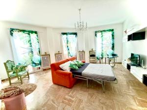 a living room with a couch and a table at Angolo prestigioso di Forlì , Wi-Fi , Parcheggio in Forlì