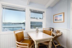 a dining room with a table and chairs and a window at Tomales Bay Lodge and Marina Inc in Inverness