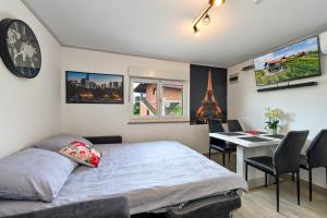 a bedroom with a bed and a table with chairs at View&Wine Jacuzzi -Tuheljske toplice in Veliko Trgovišće +41 photos
