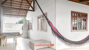Zimmer mit einer Hängematte, die an einer Wand hängt in der Unterkunft Casa em Navegantes próxima a Praia da Miraguaia in Navegantes