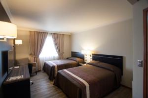 Postel nebo postele na pokoji v ubytování Hotel Diego de Almagro Osorno