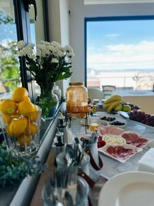 a kitchen counter with fruits and food on it at Resident Apartments Nota in Skopje