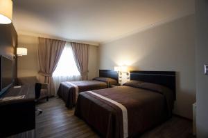 Postel nebo postele na pokoji v ubytování Hotel Diego de Almagro Osorno