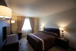 Postel nebo postele na pokoji v ubytování Hotel Diego de Almagro Osorno