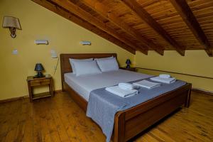 a bedroom with a bed with towels on it at Symi Garden Studios in Symi
