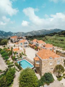an aerial view of a house with a swimming pool at Arnaoon Village in Batroûn