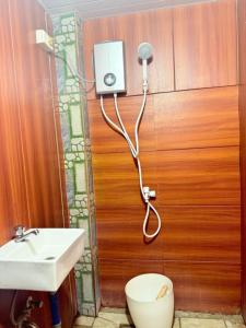a bathroom with a toilet and a sink at Mountain cove villa in Pagudpud