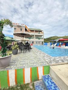 a resort with a swimming pool and a building at Mountain cove villa in Pagudpud +3 photos