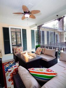 a living room with couches and a ceiling fan at The Nest in Mobile