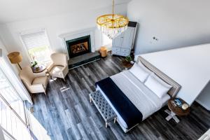 an overhead view of a bedroom with a bed and a fireplace at The Watermark Hamptons in Eastport +73 photos