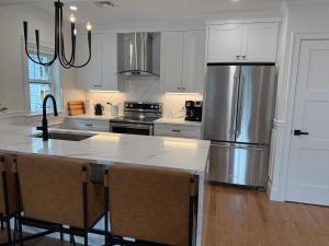 a kitchen with a large stainless steel refrigerator at Boston First floor condo in Framingham