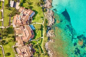 an aerial view of a house next to the ocean at Luxury Seafront Apartment - Beach Access - Parking & WiFi - by Coral Property in Porto Cervo +51 photos