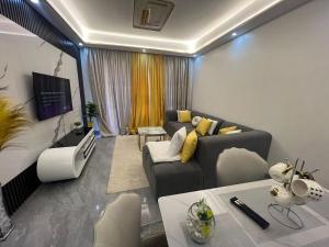 a living room with a couch and a tv at Urban Host Pro in Nairobi