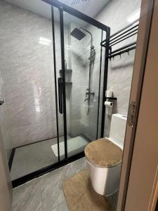 a bathroom with a glass shower with a toilet at Urban Host Pro in Nairobi +22 photos