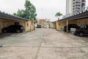 a parking lot with two cars parked next to a building at Hotel Florida in Concordia +17 photos