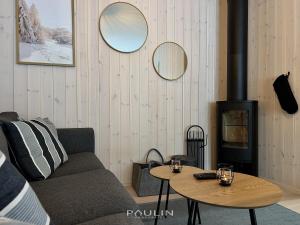 a living room with a couch and a wood stove at Lindvallen Ski Resort Pool and Padel - Sauna - 8 Guests in Sälen
