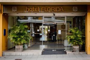a hotel front door with two palm trees in front of it at Hotel Florida in Concordia