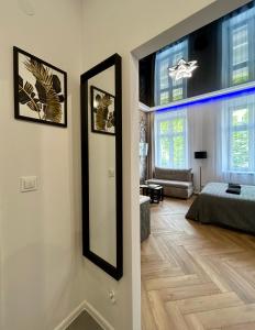 a living room with a mirror and a bedroom at Sky Mirror jacuzzi in Kraków +9 photos