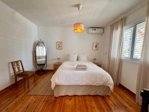 a bedroom with a bed and a mirror and a chair at Liberty House - Central Two Bedroom Apartments in Nicosia