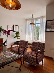 a living room with two chairs and a table at Liberty House - Central Two Bedroom Apartments in Nicosia