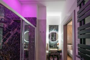 a purple bathroom with a sink and a mirror at Olimpico Luxury Rooms in Rome +48 photos