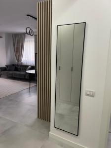 a glass cabinet on a wall in a living room at Apartament A&Maya in Râmnicu Vâlcea