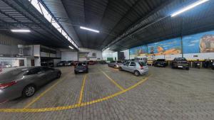 a group of cars parked in a parking lot at Real Hotel in Juiz de Fora