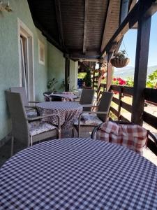 a checkered table and chairs on a patio at Privatan smeštaj Velić in Donji Milanovac +24 photos