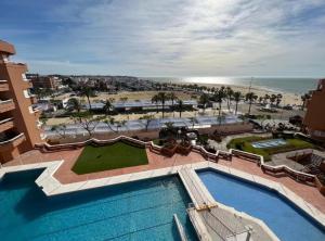 an aerial view of a resort with a swimming pool and the beach at Mirador de Sanlucar 3 in Sanlúcar de Barrameda