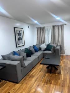 a living room with a couch and a table at Urban beautiful home Jersey City 15 mins from NYC 15 mins from Newark airport in Jersey City