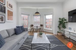 a living room with a couch and a table at 304 Newbury Street by Thatch in Boston