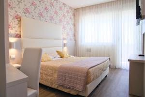 Postel nebo postele na pokoji v ubytování Hotel Benini