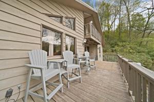 a deck with chairs and a table on a house at Riverside Mountain Retreat in Boone