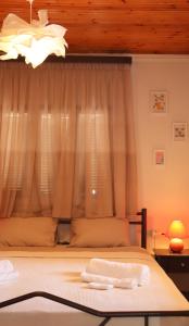 a bedroom with a bed with a window at Charming Villa by the Sea in Nea Kalikratia