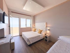 Postel nebo postele na pokoji v ubytování Hotel Benini