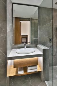 a bathroom with a sink and a mirror at Le Meridien Hyderabad in Hyderabad