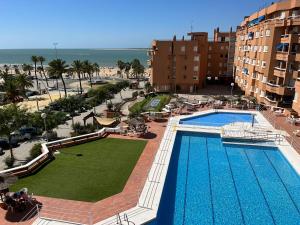 a view of a swimming pool and the beach at Mirador de Sanlucar 3 in Sanlúcar de Barrameda