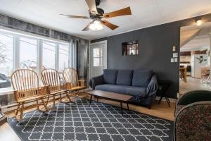 a living room with a blue couch and chairs at Blanche du Cap A stone's throw from Le Massif in Charlevoix in Petite-Rivière-Saint-François