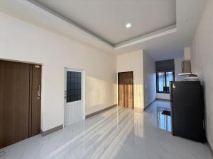 a large white room with a kitchen and a refrigerator at Baan Santi in Koh Phangan in Thongsala +8 photos