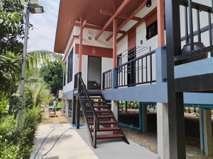 a house with a staircase leading up to it at Baan Santi in Koh Phangan in Thongsala