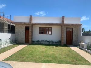 a house with a lawn in front of it at Sunset Patacho in Pôrto de Pedras