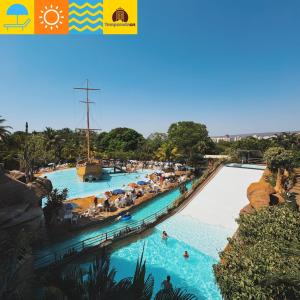 a pool at a water park with people in it at Piazza diRoma com acesso ao Acqua Park - Temporada CN in Caldas Novas