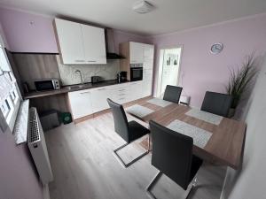a kitchen and dining room with a table and chairs at Ferienwohnung Hochwaldblick 4 in Morbach +6 photos