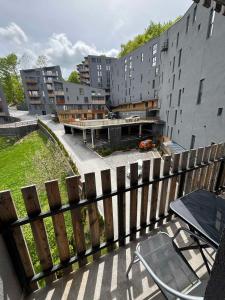 a balcony with a fence next to a building at NINA LUX Apartment in Mavrovo