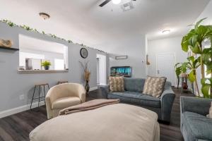 a living room with two chairs and a couch at Family Retreat Near NAS JAX and Orang Park Mall with Gameroom in Jacksonville