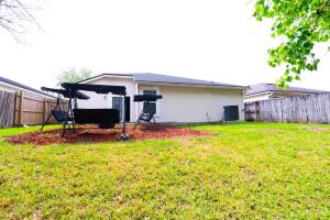 a backyard with a tent and two chairs in a yard at Family Retreat Near NAS JAX and Orang Park Mall with Gameroom in Jacksonville