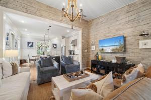a living room with a couch and a table at 67 Wiggle Lane - Rosemary Beach - Steps to Tennis Courts, Beach, Pools! in Rosemary Beach