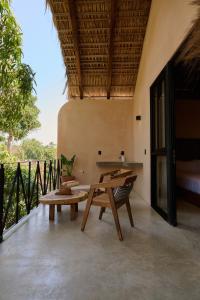an outdoor patio with a table and a bench at Pan Beach in Brisas de Zicatela